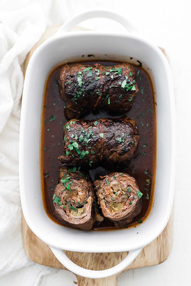 beef rouladen slices in a dish with gravy