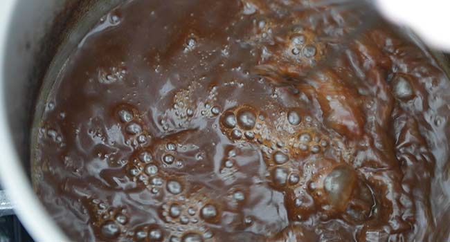 cooking down a beef stock into gravy