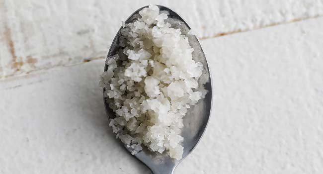 grey salt or celtic salt in a spoon