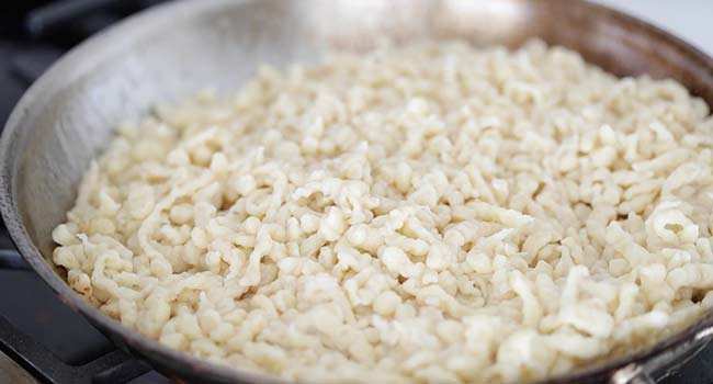 cooking spaetzle dough in a pan