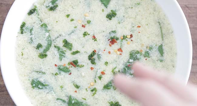 garnishing stracciatella with pepper flakes