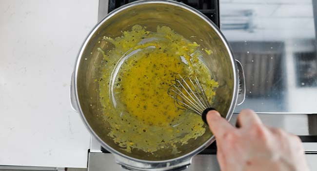 whisking egg yolks and a shallot reduction