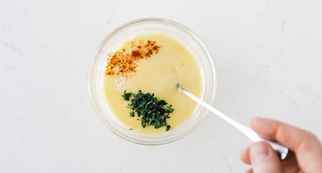 mixing garnishes into a bearnaise sauce