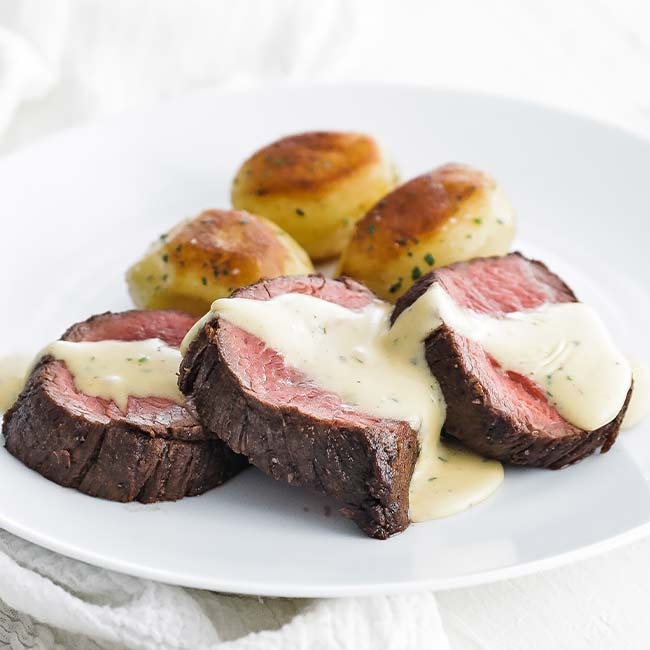 châteaubriand beef on a plate with potatoes