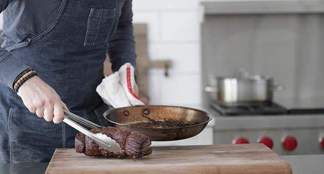 resting beef tenderloin on a cutting board