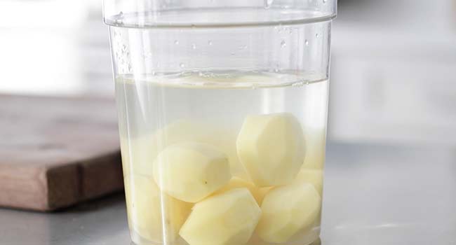 peeled potatoes in water