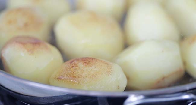 browning potatoes in a pan