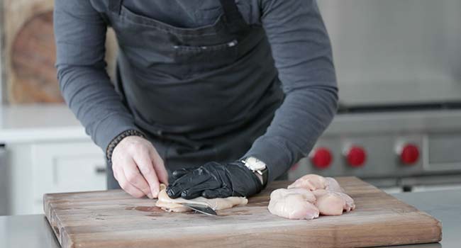 slicing a chicken breast in half