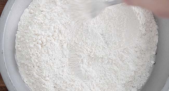 mixing together flour with salt and pepper