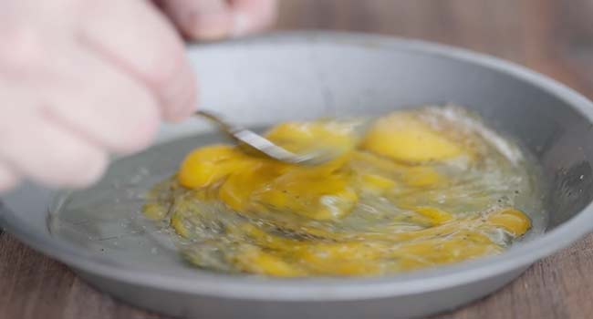 Whisking together eggs with salt and pepper