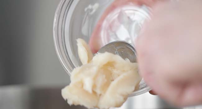 adding lard to a pan