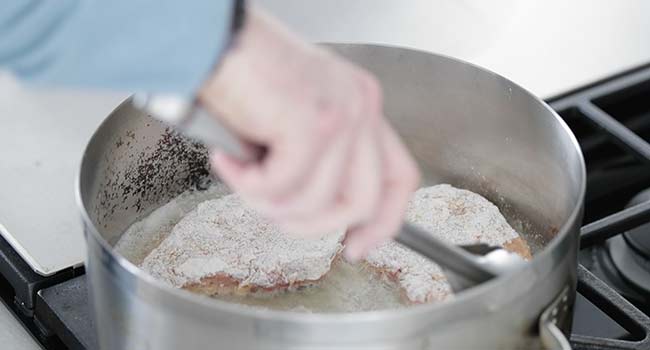 frying pork chops in a pan