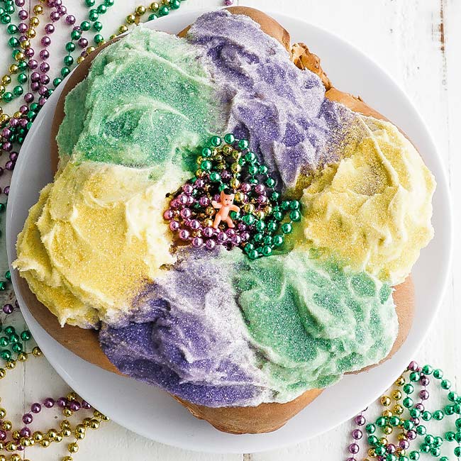 king cake on a plate with beads