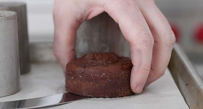 removing a chocolate cake from a baking mold