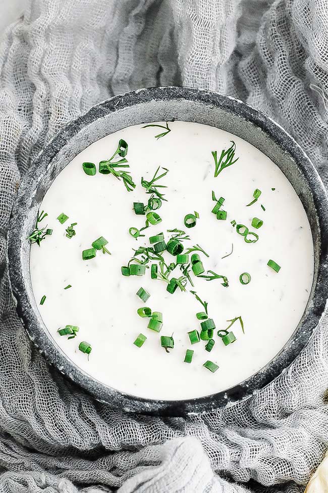 fresh dill and chives in a sauce