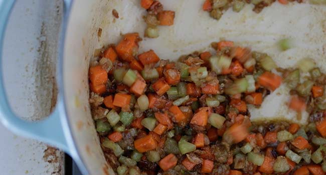 stirring spices into a cooked vegetables