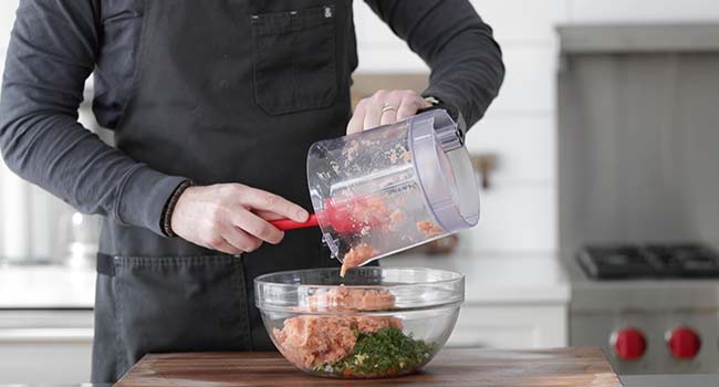 adding finely prepared salmon to a bowl with vegetables