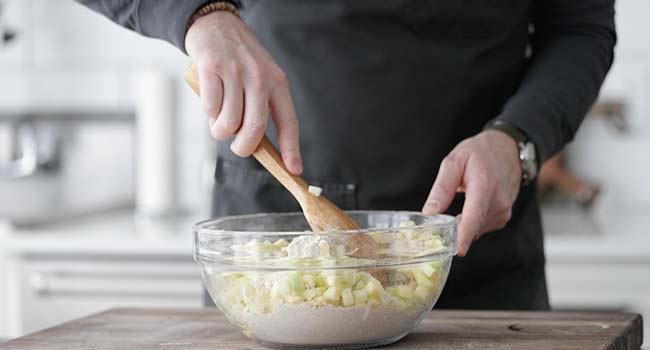 mixing apples with flour