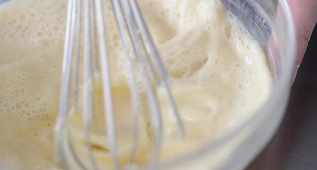 whisking together eggs and flour