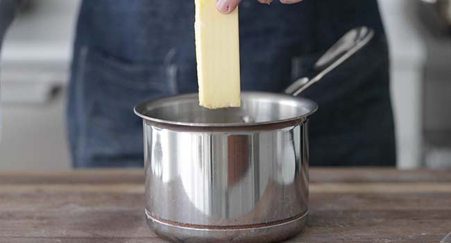adding butter to a pot