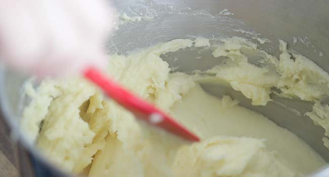 folding mashed potatoes in a pot