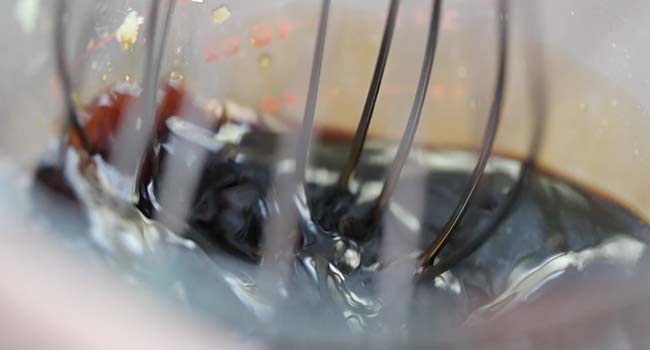 whisking a honey and soy sauce together