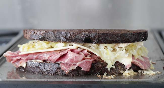 a reuben sandwich on a griddle