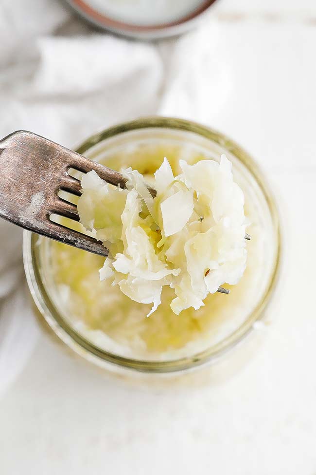 a fork full fo sauerkraut from a jar