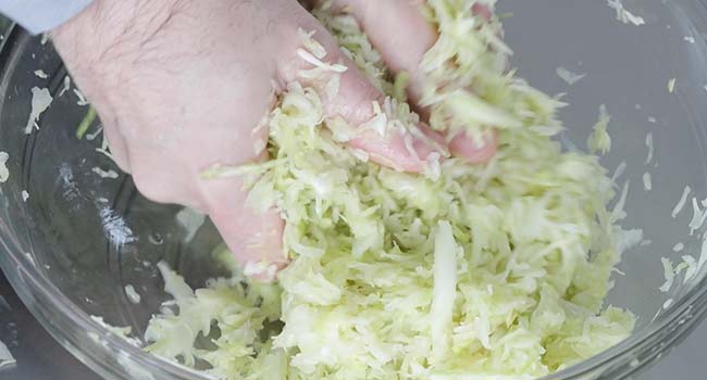 mixing cabbage and salt