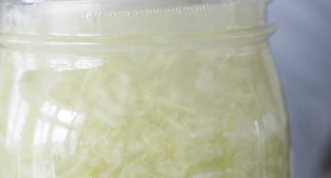 covering sauerkraut in its own liquid