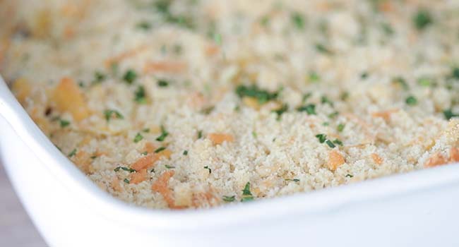 sprinkling parsley on casserole