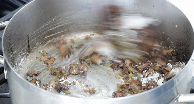 making a roux in a pan with vegetables