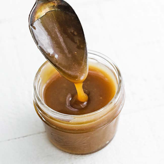 pouring caramel into a jar