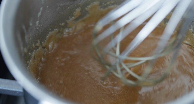 whisking caramel together in a pan