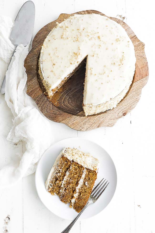 carrot cake slice next to a whole carrot cake