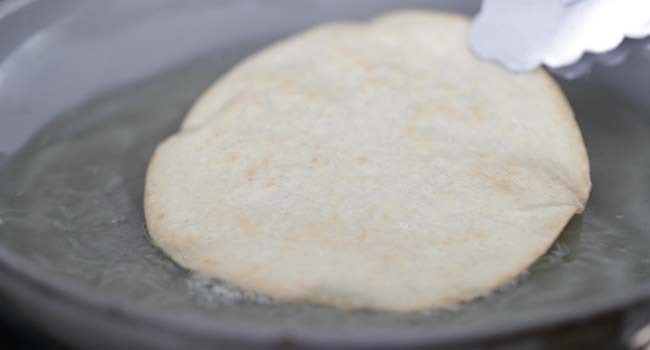 frying a corn tortilla