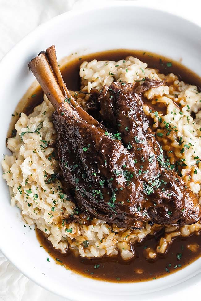 braised lamb shank with gravy and herbs