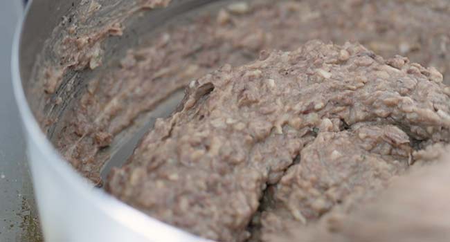 mixing melting cheese into refried beans