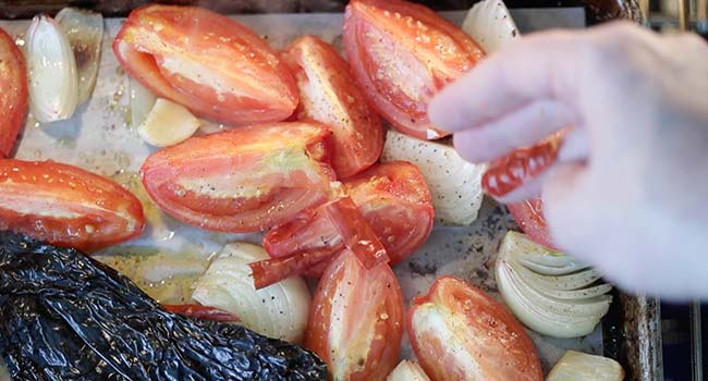 adding dried chiles to roasted vegetables