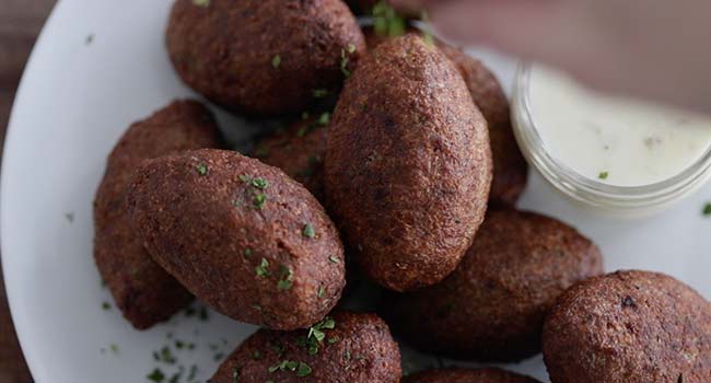 garnishing kibbeh with parsley