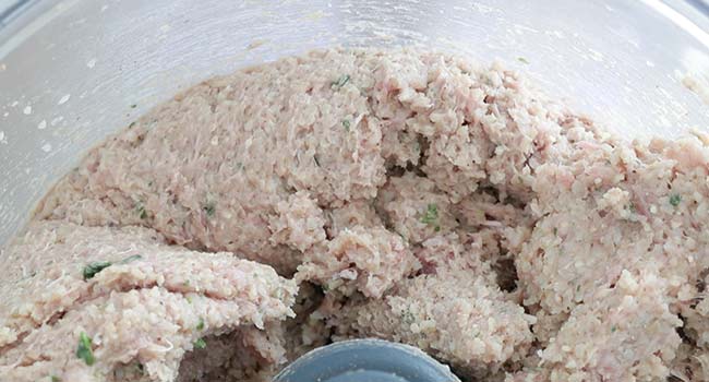 pulsing ground lamb in a food processor