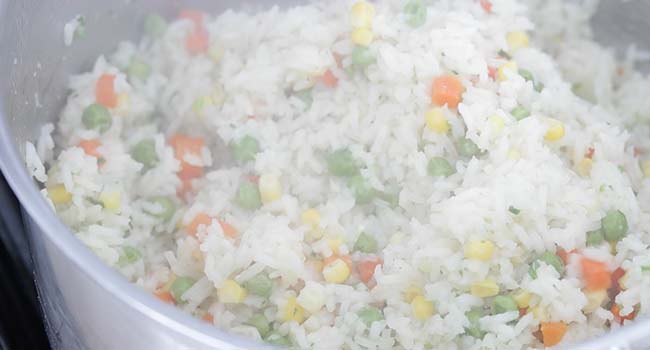 fluffing mexican white rice with a fork