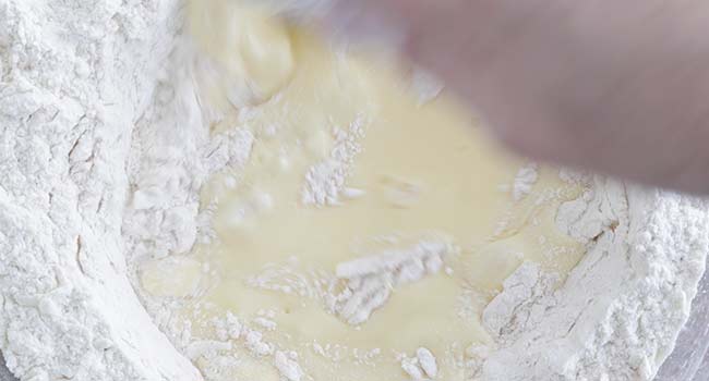 adding buttermilk to dough