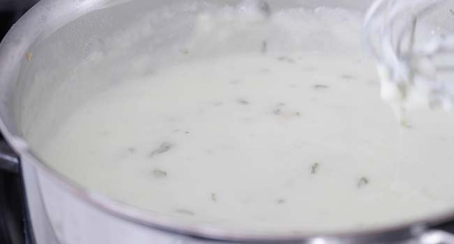 finishing a yogurt sauce with mint