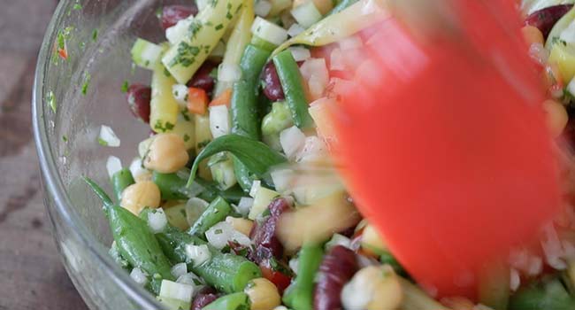 mixing together a three bean salad