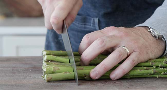 trimming the ends off of asparagus