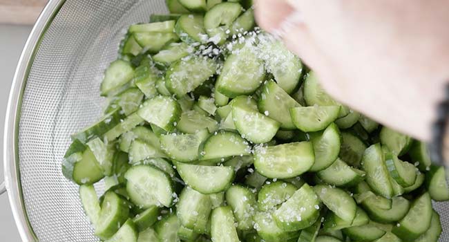 salting sliced cucumbers