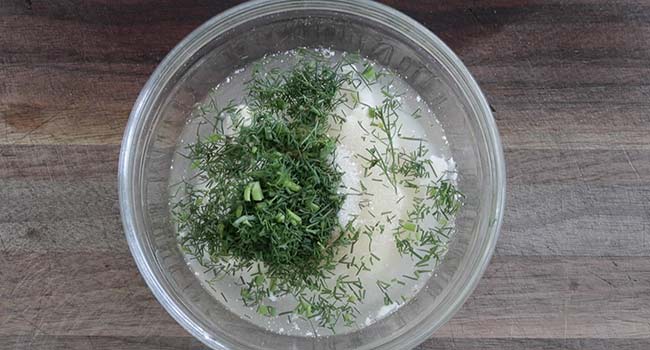 mixing together dill and mayonnaise