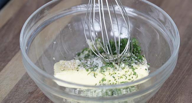 mixing together butter and herbs