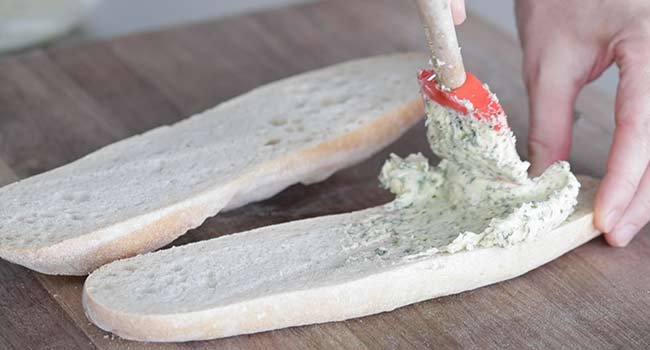 spreading herb butter on bread